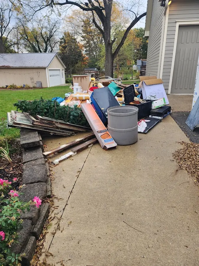 Dumpster being loaded with debris for Estate Cleanout Dumpster Rental in Somerdale